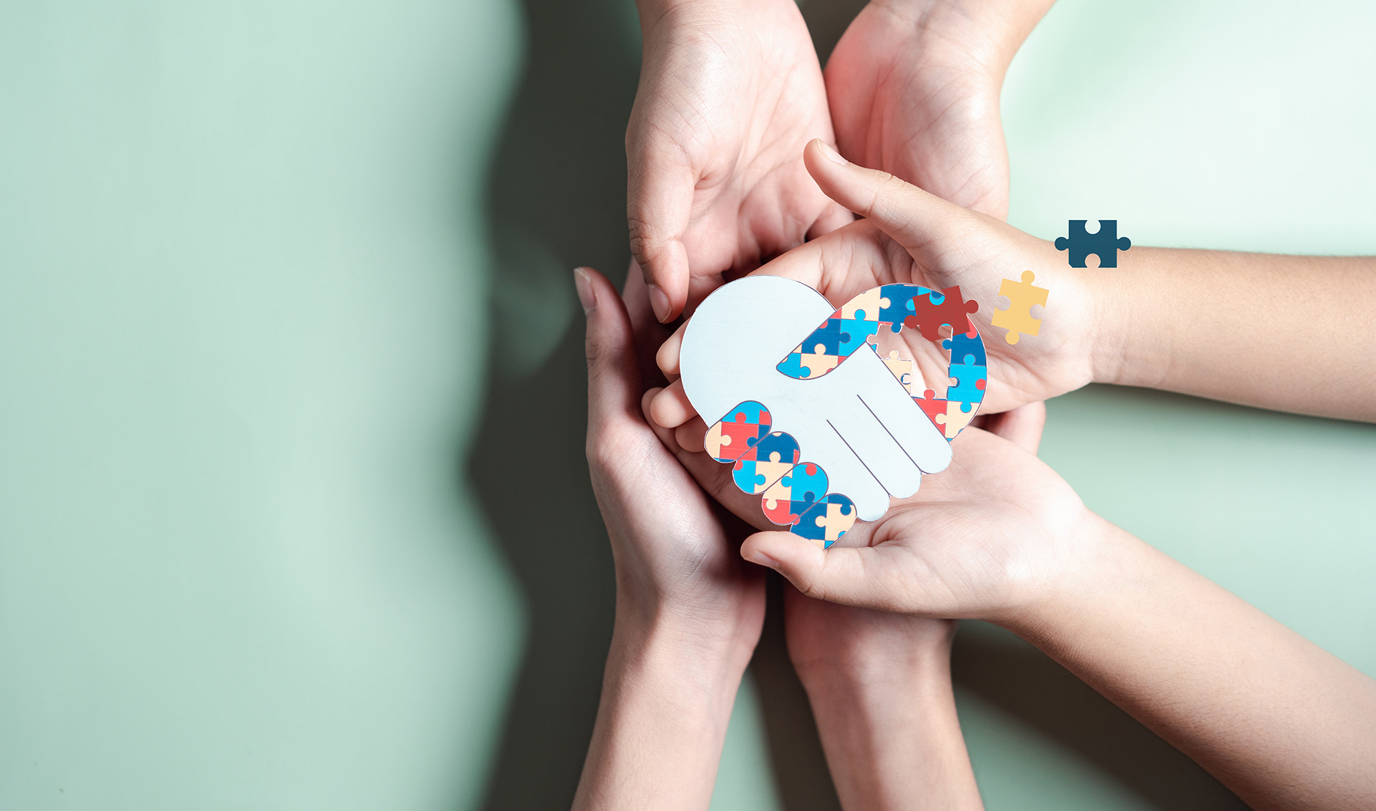 Father, Mother, Children holding heart jigsaw puzzle