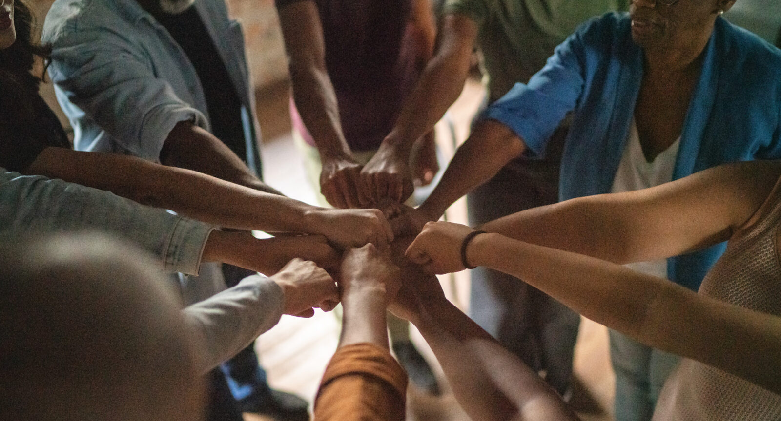 large team doing a group fist bump
